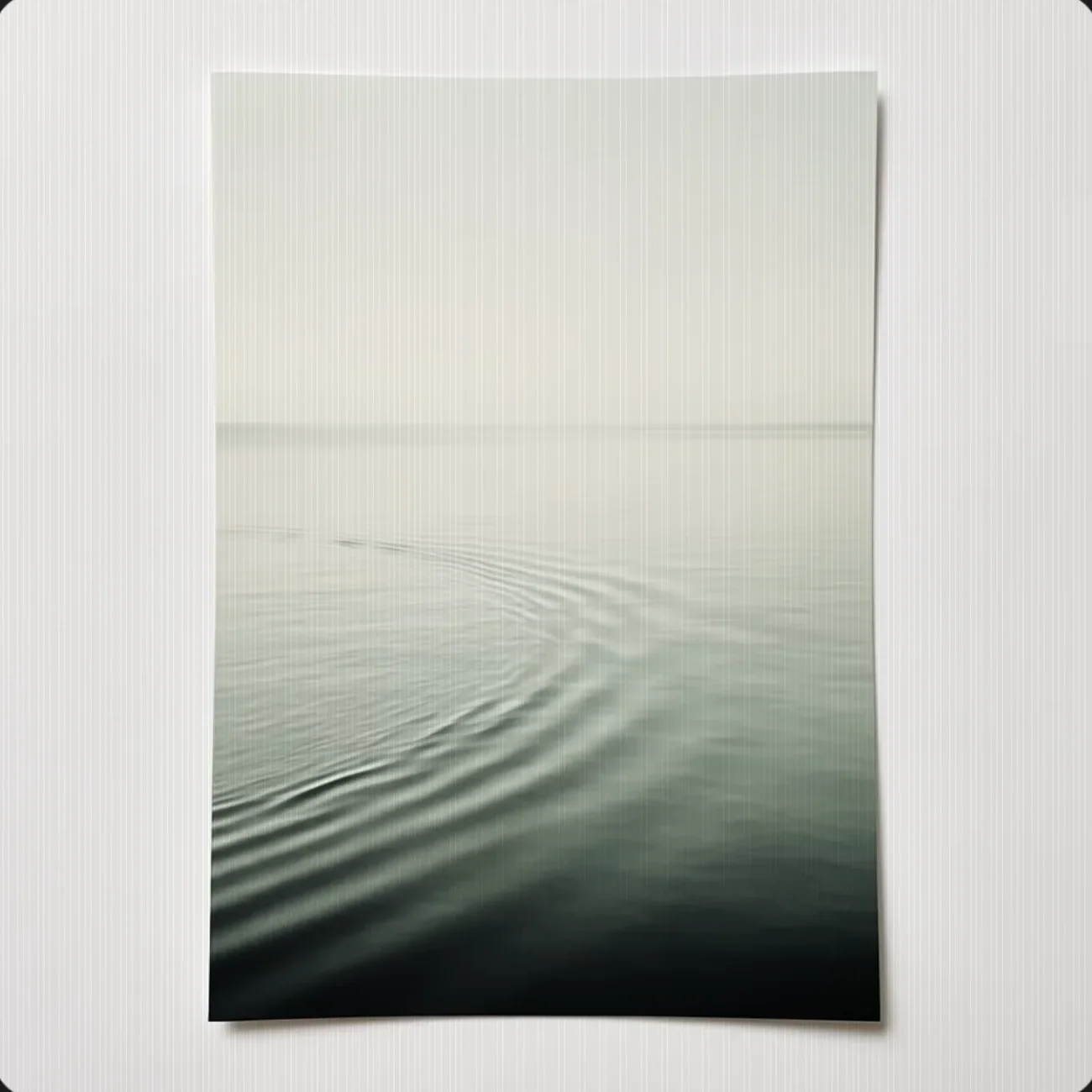 Ripples settling into a still pale surface